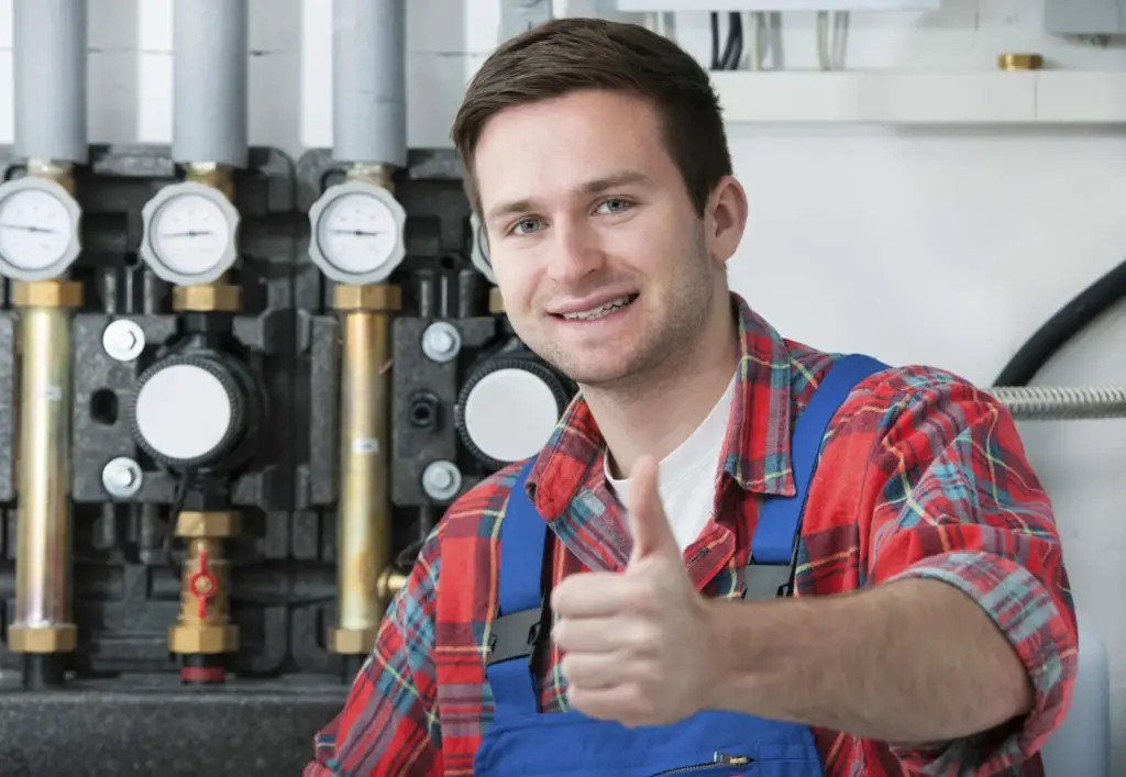 Heat pump service engineer servicing a heat pump